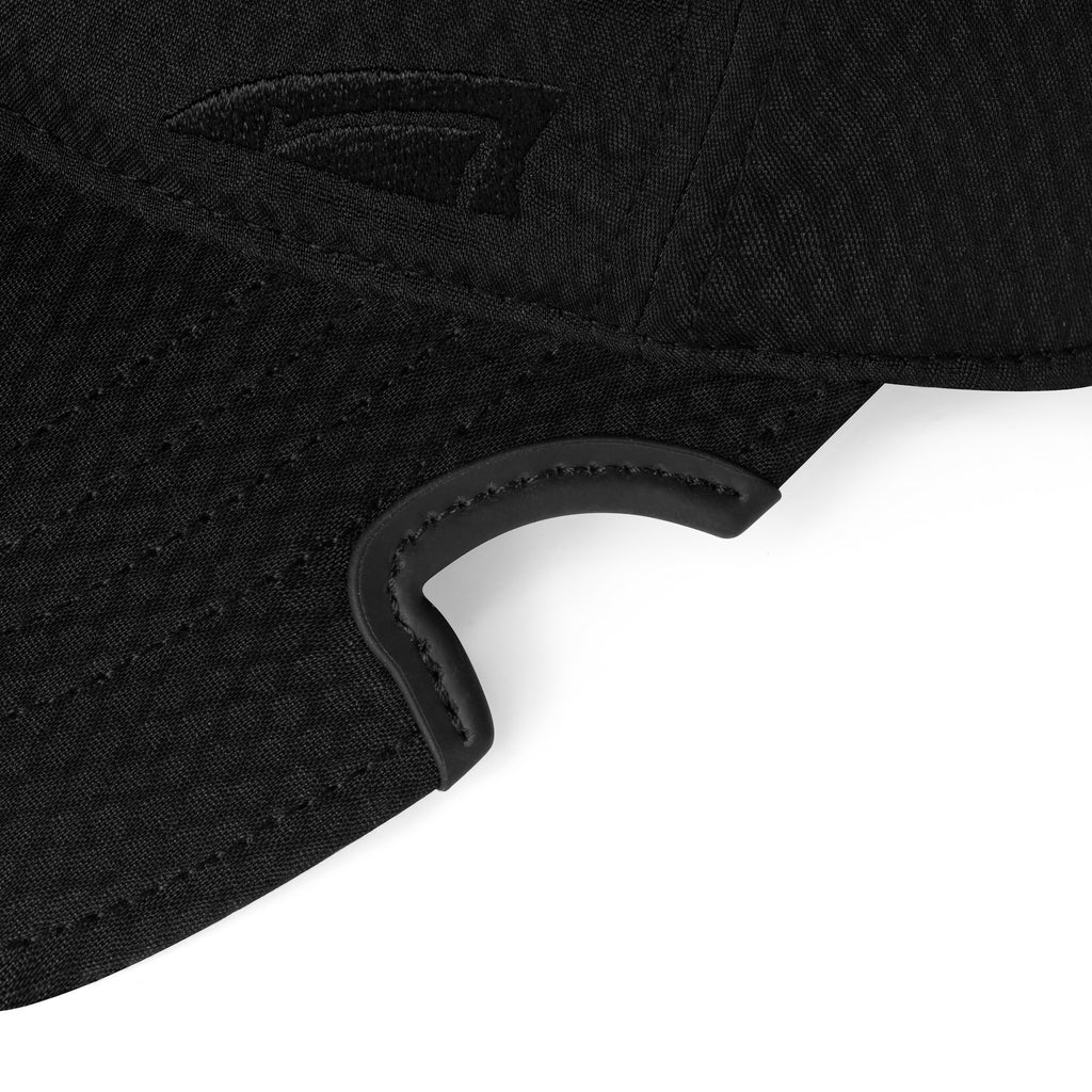 Close-up detail of patented notch on black Notch Athlete performance cap brim with Notch logo