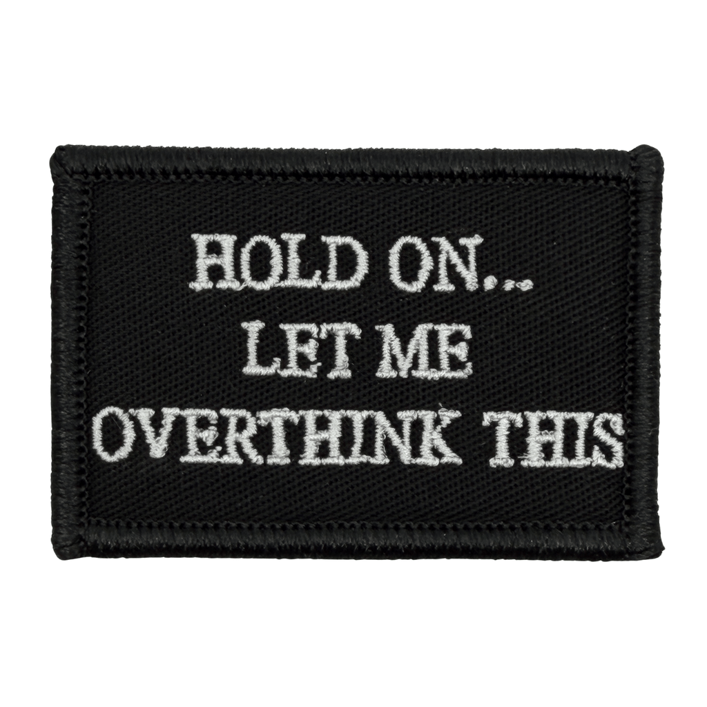 Black patch with white text 'HOLD ON... LET ME OVERTHINK THIS' white text onb black background