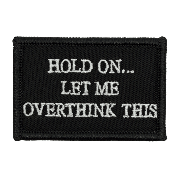 Black patch with white text 'HOLD ON... LET ME OVERTHINK THIS' white text onb black background