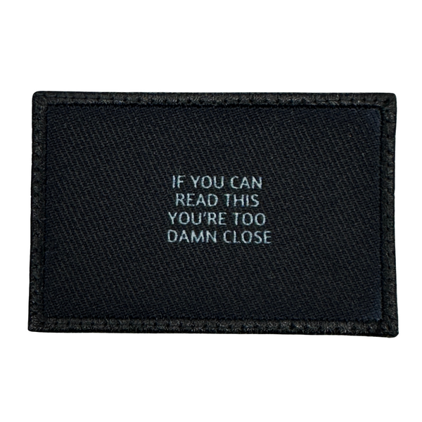 If You Can Read This You Are Too Damn Close Patch - Black-White  Embroidered Patch - Black-White,
Hook fastener backing,
Made in the USA,
2" x 3" sized for our tactical/operator caps 