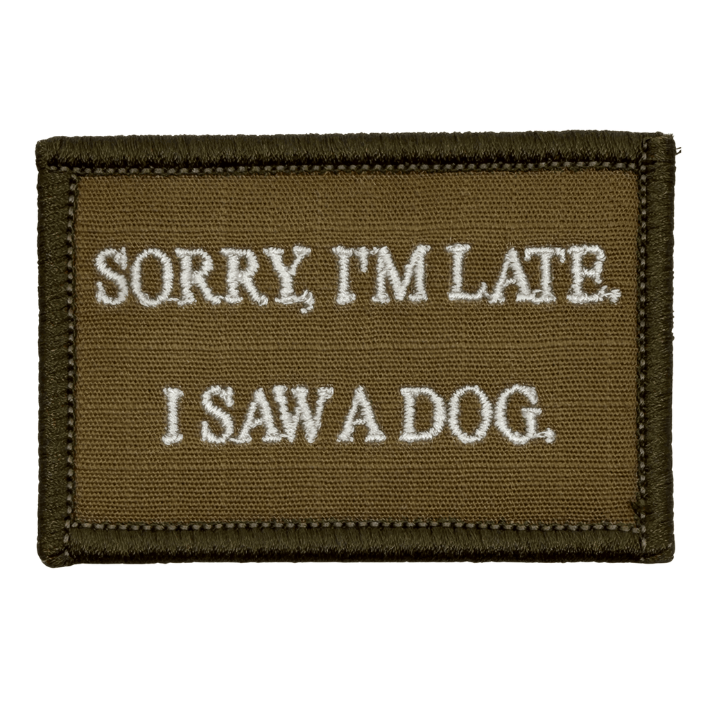 Brown Embroidered patch with white text 'Sorry, I'm late. I saw a dog.' on a white background. Hook and loop backing.