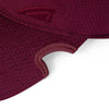 Close-up detail of patented notch on burgundy Notch Athlete performance cap and Notch logo