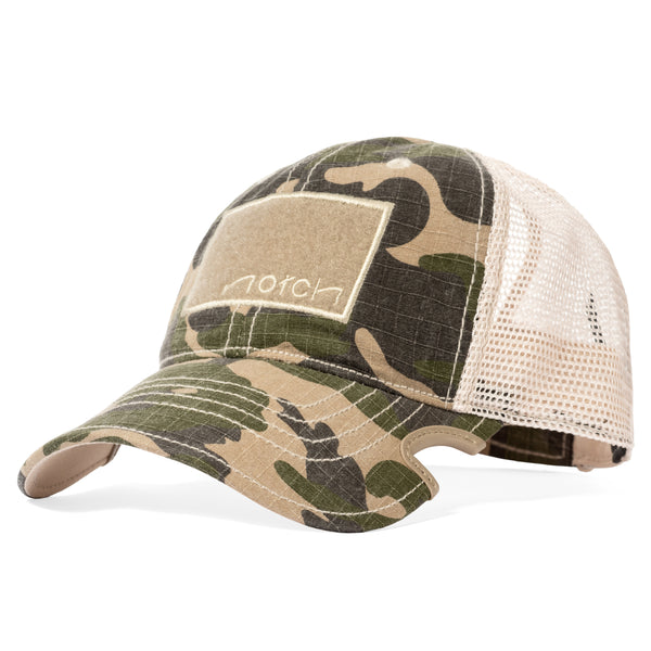 Notch Classic Adjustable Camo Ponytail Operator Camo bill on Baseball hat with notch cut out in the bill that eliminates the fight between you hat and sunglasses, tan mesh back with adjustable hook and loop strap, ponytail slot in the back of the hat, front 2 inch by 3 inch tan loop field that allows you to affix morale patch or American Flag patch of your choice 